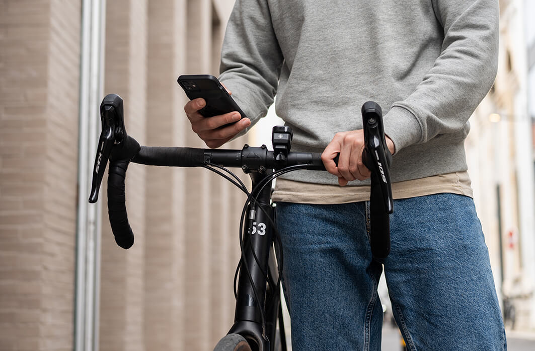 A cyclist charging his phone on a bike ride